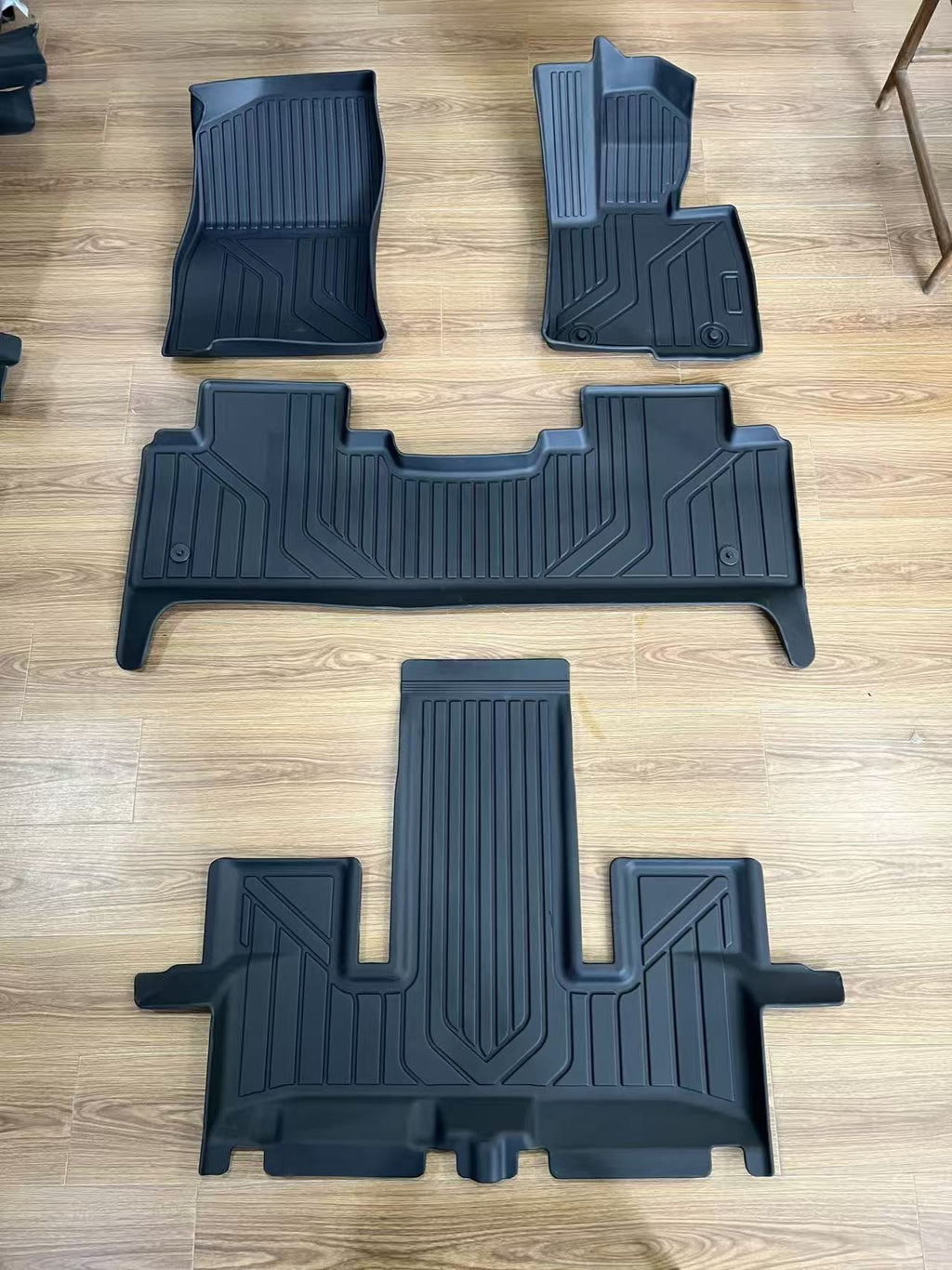 Denza B8 black multi-piece floor liners laid out on floor
