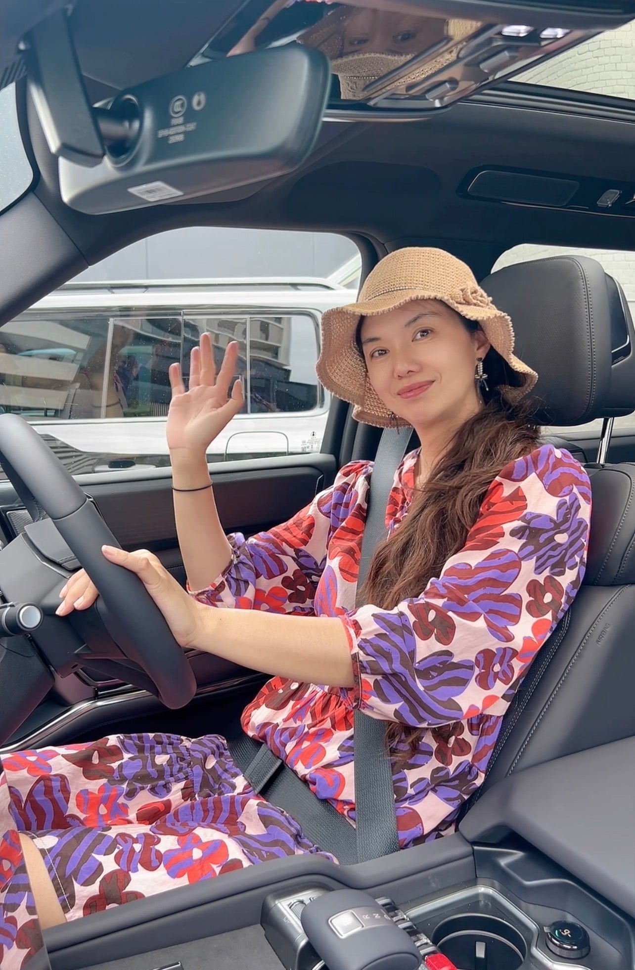 Mum, co-founder of EV-Mart, driving an electric vehicle